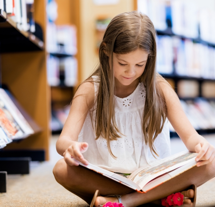 girl with long hair reading book